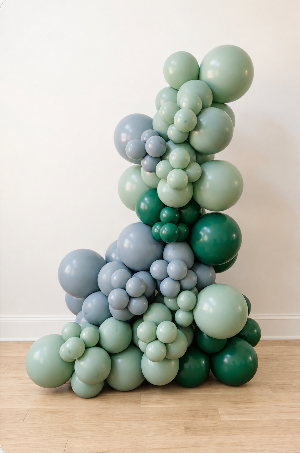Freestanding organic balloon garland in sage, forest green and slate blue