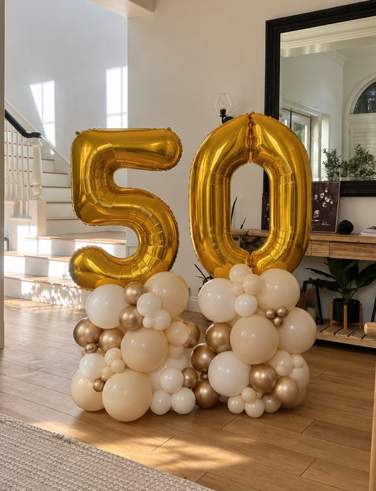 Gold 50 foil balloon number stacks with sand, ivory and chrome gold balloon clusters